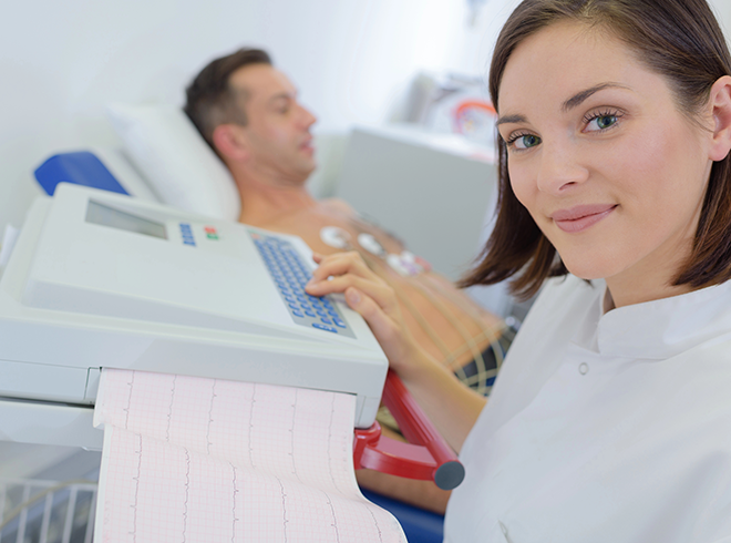 Healthcare technician performing ECG test on male patient, capturing cardiac monitoring and diagnostic support in cardiovascular care