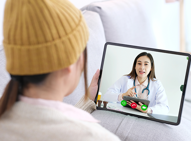 Patient using tablet for virtual consultation with female doctor, illustrating telehealth services, remote care delivery, and digital patient engagement