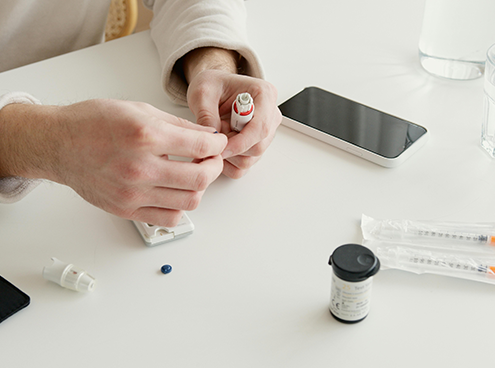 Patient preparing medication dose at home during Chronic Care Management session